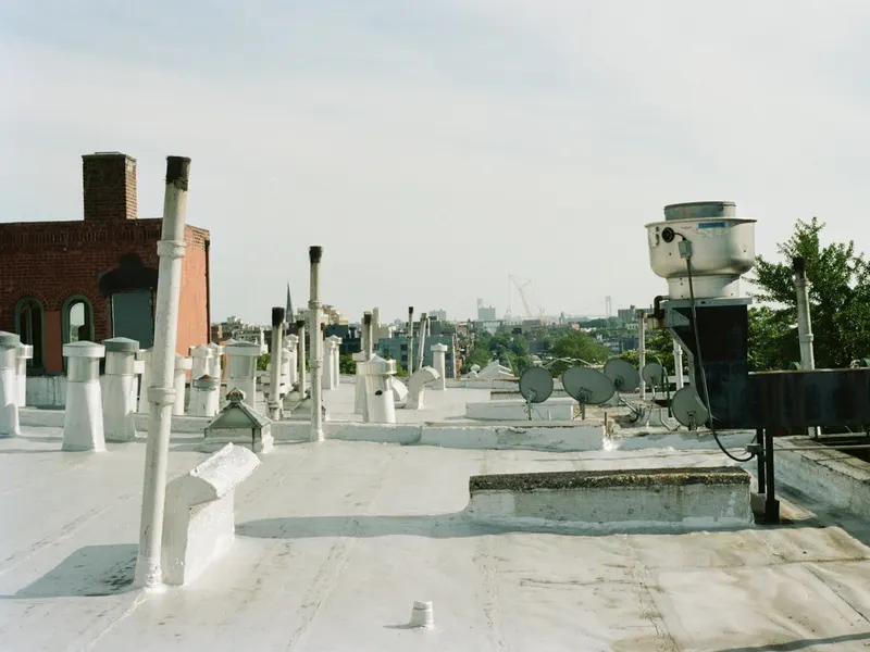 A flat commercial roof with its vents and drains